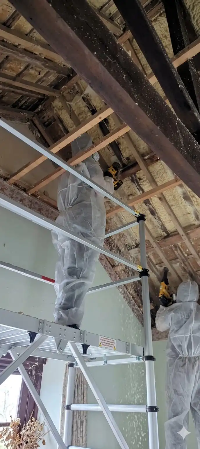 A Spray Foam Removal Specialist removing closed cell spray foam from an internal scaffold.